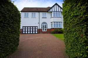 Typical 1930s white semi detatched house with large driveway