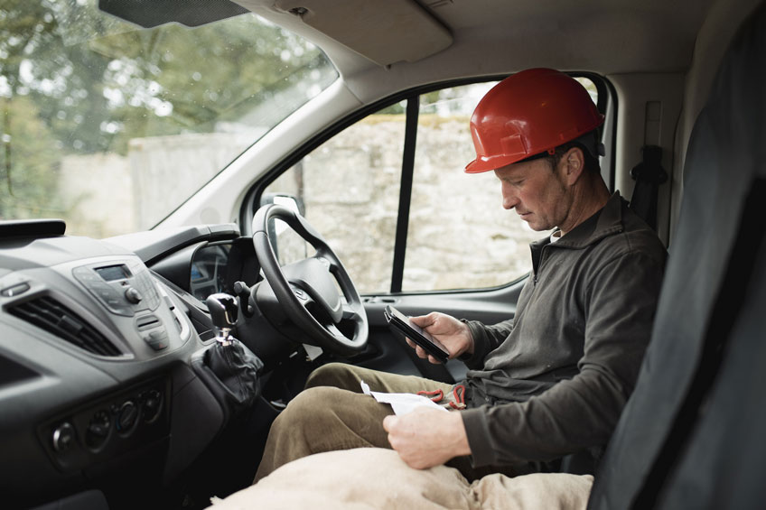 tradesman invoicing on phone