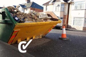 Skip on a road filled with rubbish.