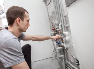 Engineer checking boiler pipework – relocating boiler