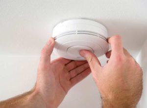 Person installing fire alarm 