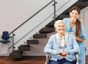 Elderly woman sitting in front of stair lift