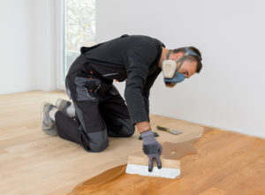 Flooring specialist restoring wood floor
