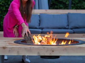 Putting wood in a garden fire pit