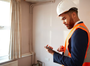Surveyor identifying issues with property
