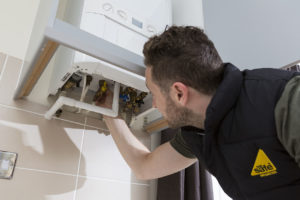 gas safety engineer checking boiler