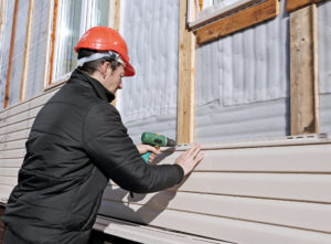 Cladding expert installing new house cladding