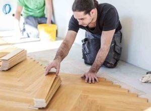 herringbone floor installation by tradesperson
