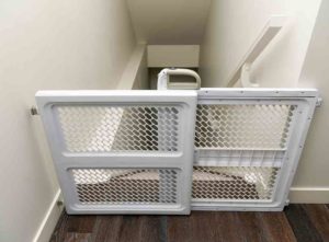 Baby gate at top of steep staircase