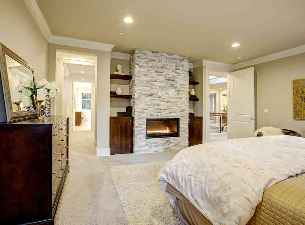 Stone tiled chimney breast in bedroom