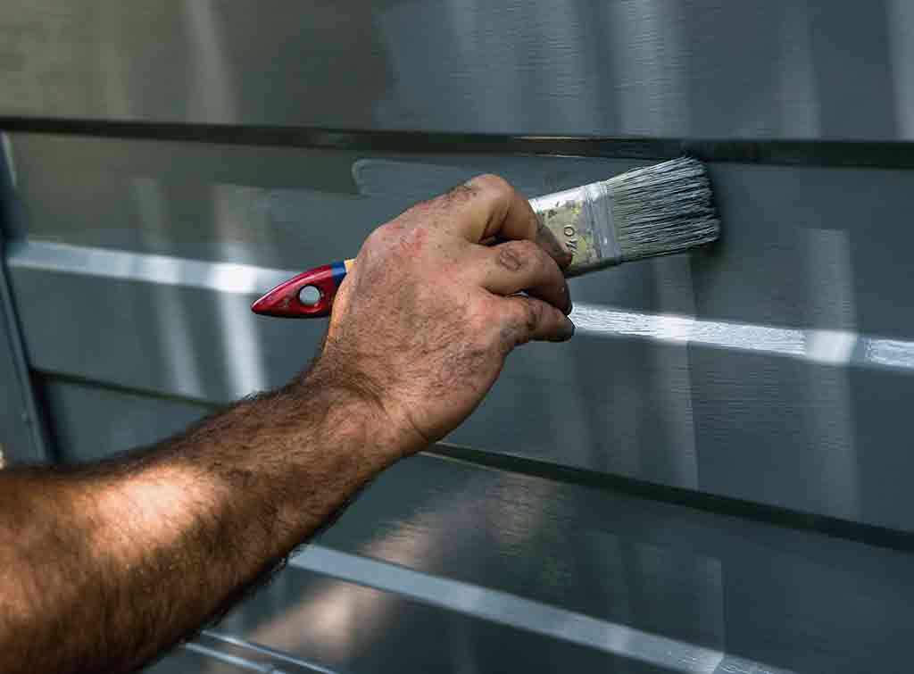 Painting garage door with a brush
