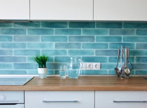 A turquoise blue tiled kitchen splashback