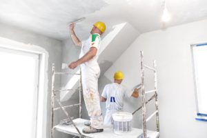 professionals plastering a room