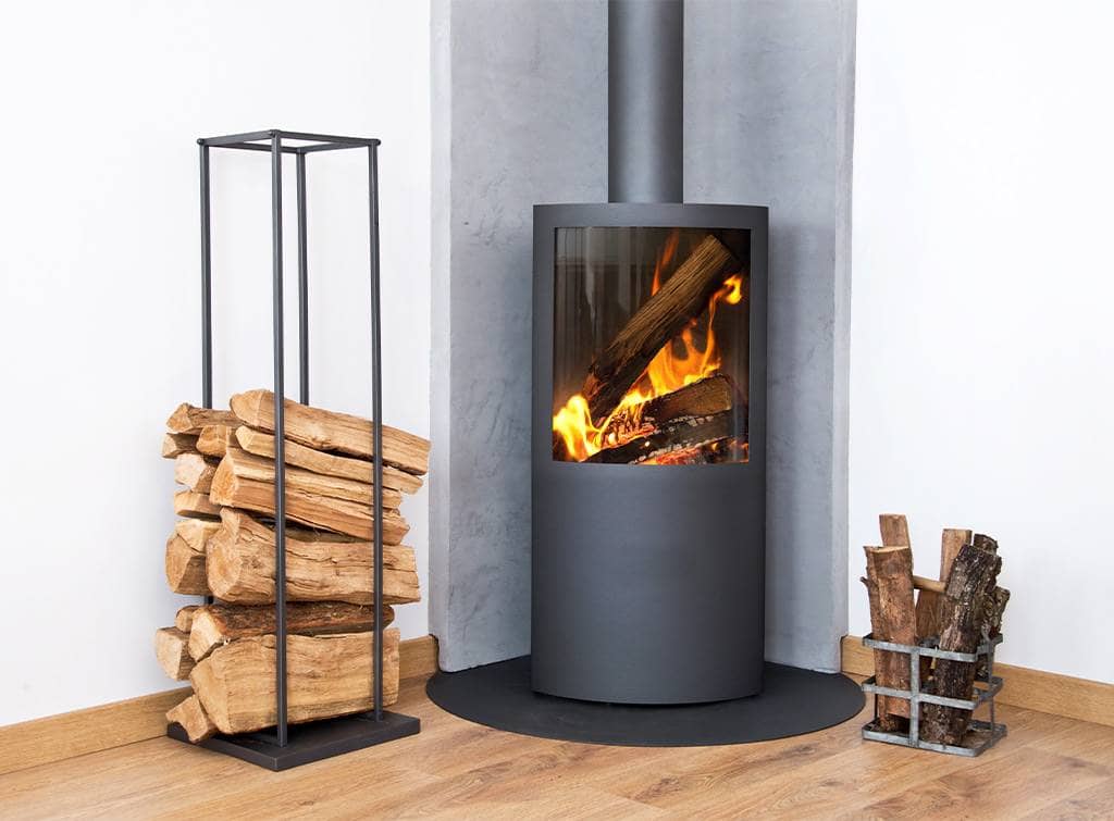 A log burner surrounded by logs