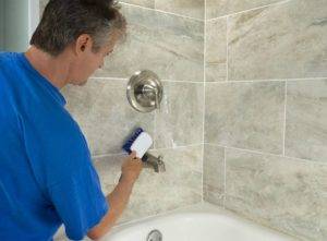 Professional tile cleaner scrubbing tiles