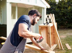 Man teaching how to build a garden summer house
