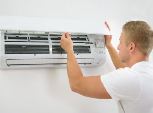 Engineer installing air conditioner unit