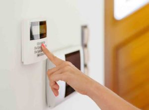 woman pressing home alarm button
