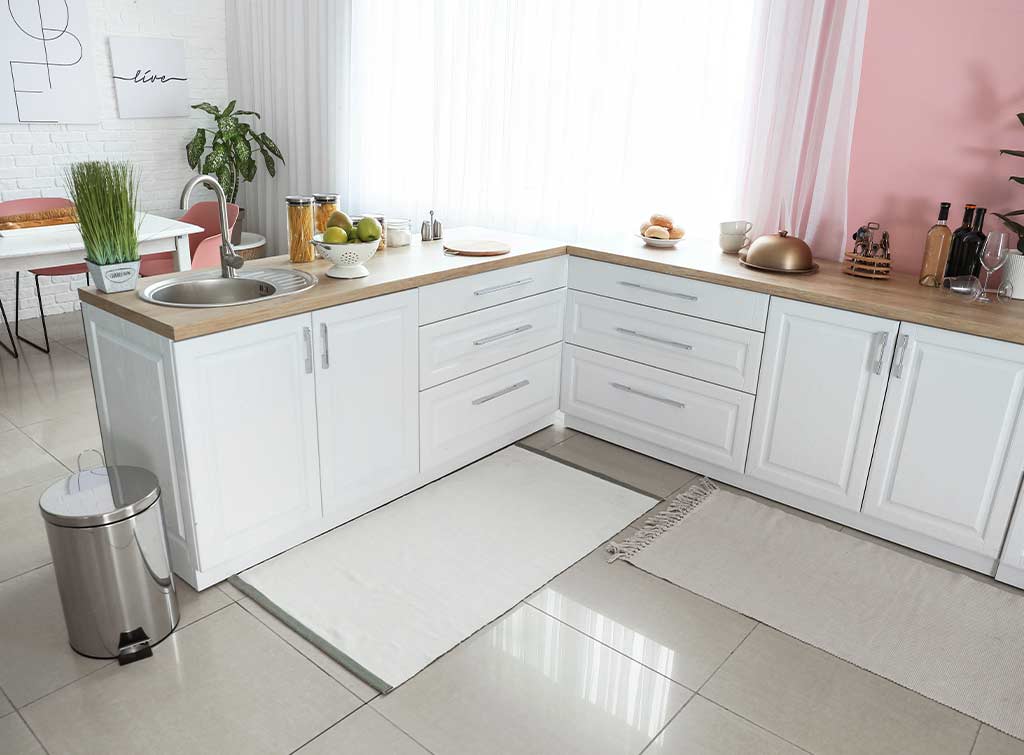 Cheap kitchen floor makeovers - white rugs in a white kitchen