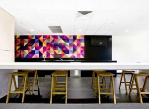 Inexpensive tiled kitchen splashback using brightly-coloured tiles