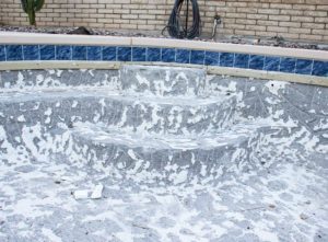 Swimming pool with tiles removed - concrete pool resurfacing cost