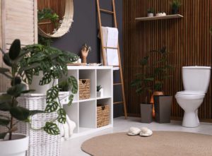 A bathroom with shelving, ladders,and plants - small bathroom makeover ideas on a budget
