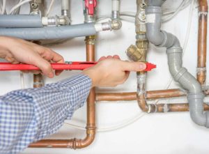 engineer fixing boiler pipes