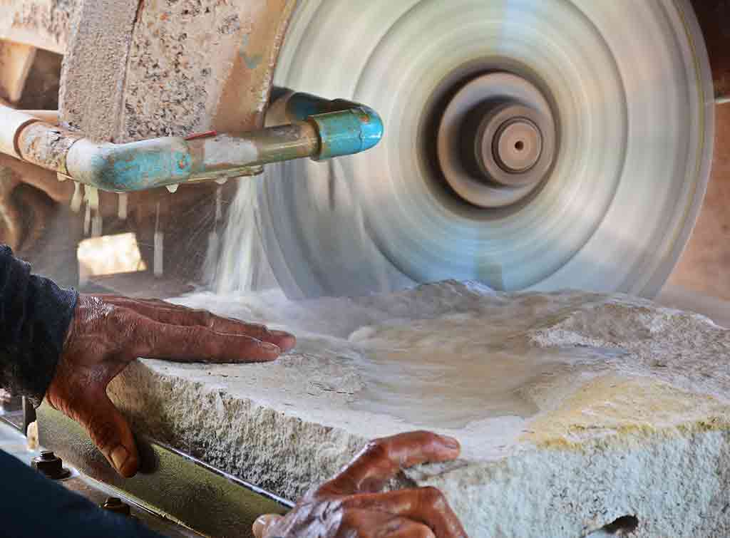 Stonemason using stone cutting wheel