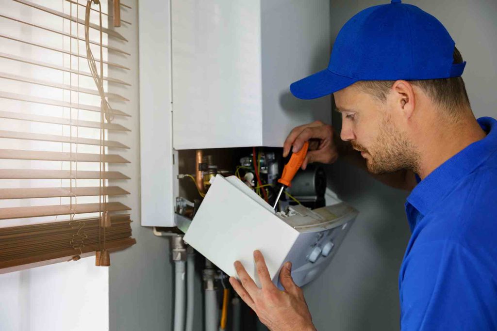 gas engineer fixing boiler