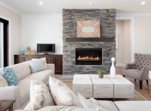A white room with a stone chimney breast - cheap chimney breast makeover for your fireplace