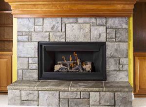 A fireplace with a wooden mantel can be painted over for a new look - Cheap fireplace makeover with a painted mantel