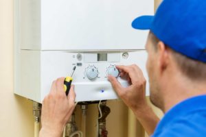 Broken boiler being repaired by engineer
