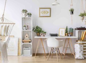 Home office desk with plants on and around it - green home office makeover ideas