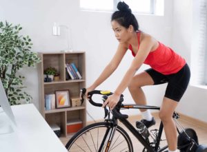 Women cycling on a turbo trainer indoors