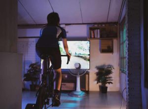 Indoor cycling studio - woman on static bike doing a workout