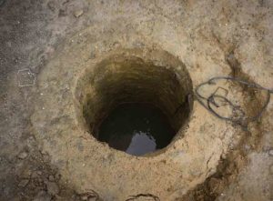 A well with water in it - water well drilling cost