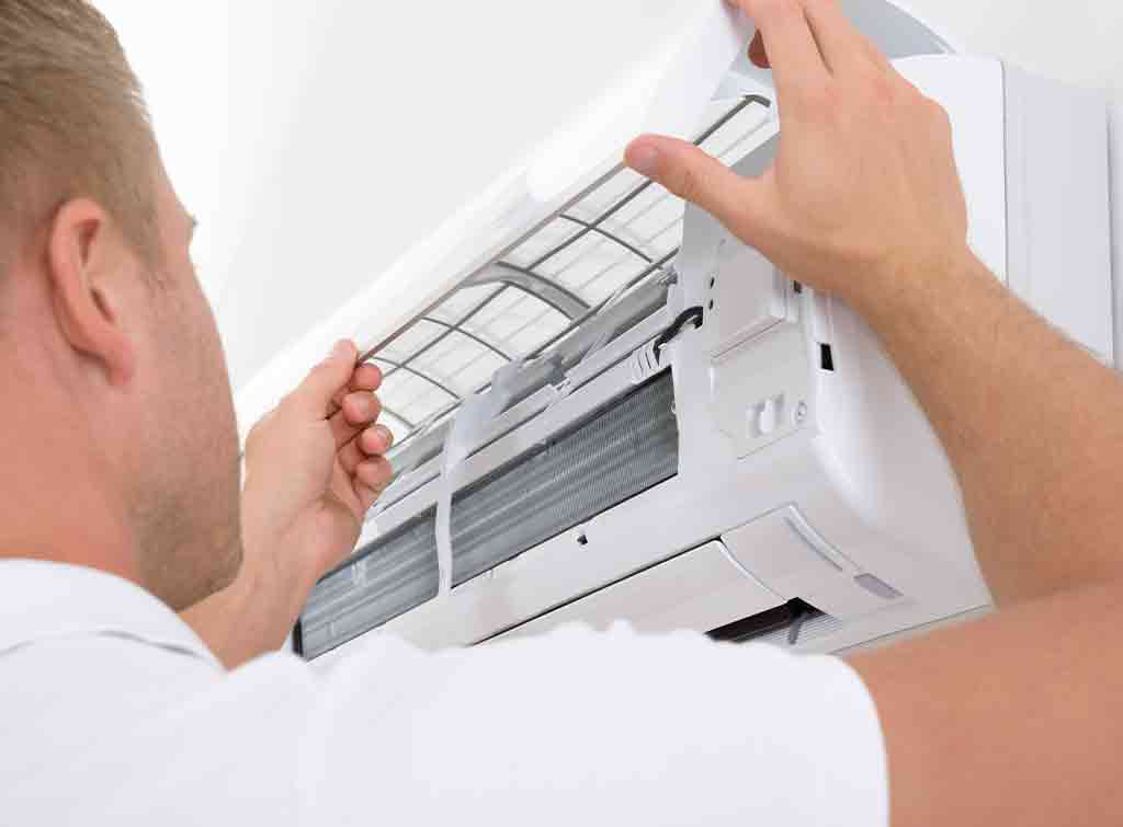 Air conditioning engineer installing unit