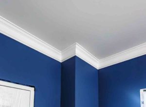 Crown molding installed on blue wall