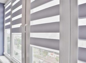 Cheap window blind ideas. Image: White stripped blinds on glass window