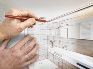 How to design a small bathroom. Image: Render of a drawing of bathroom with a hand holding a pencil over the picture
