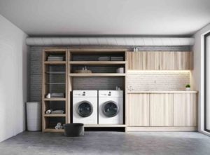 A washer/dryer set in a wooden shelving unit - utility room remodel cost