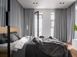 Bedroom with floor to ceiling grey curtains