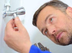 Plumber inspecting electric shower not working