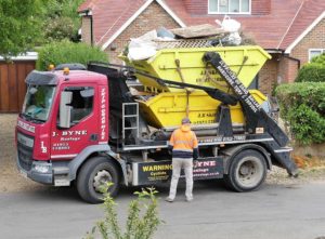 Removing topsoil in a skip