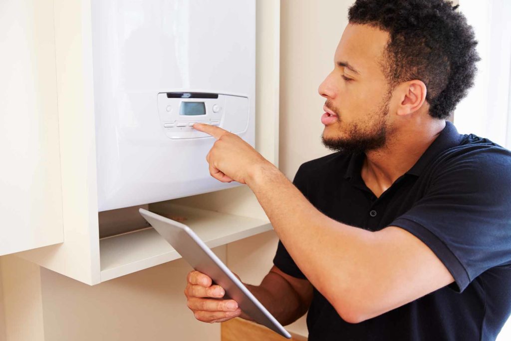 Plumber fixing a boiler