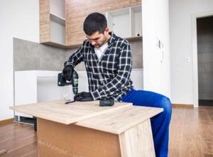 Handyman assembling furniture