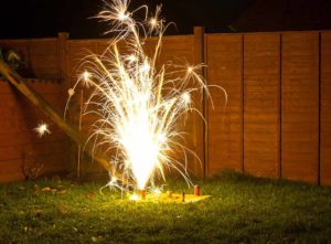 silent fireworks alight in a back garden