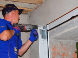 A tradesperson removing a garage door