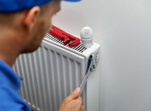 plumber fixing a cold radiator