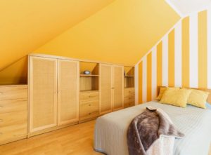 Fitted wardrobe in bright coloured room